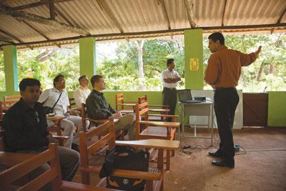 man talking to room of students